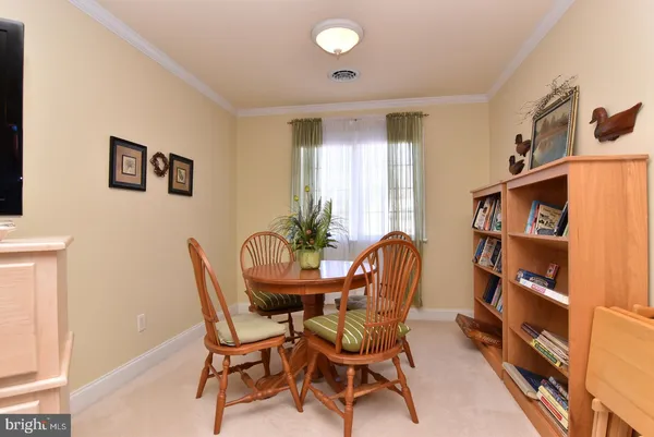 a dining room with furniture and a book shelf