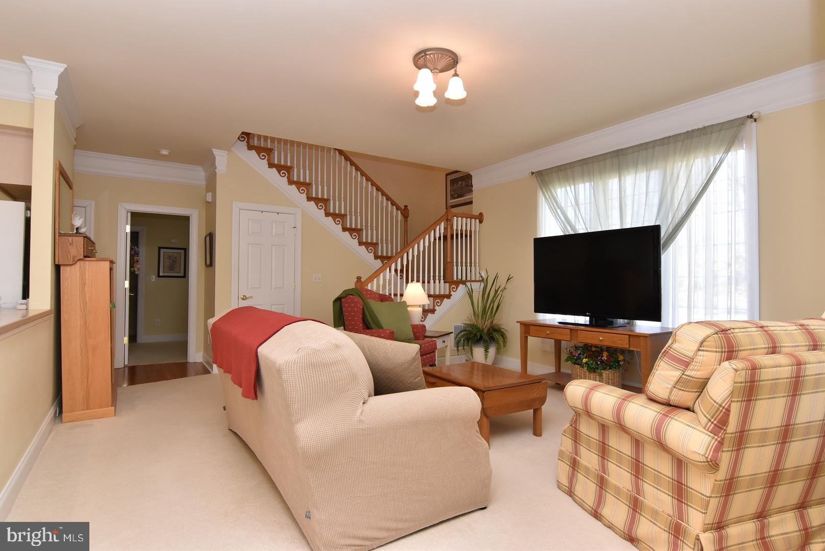 204 Turtle Cove, Unit 115 Laurel, DE 19956 - Photo 3 of 47 a living room with furniture and a flat screen tv