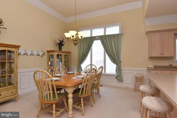 a view of a dining room with furniture and chandelier