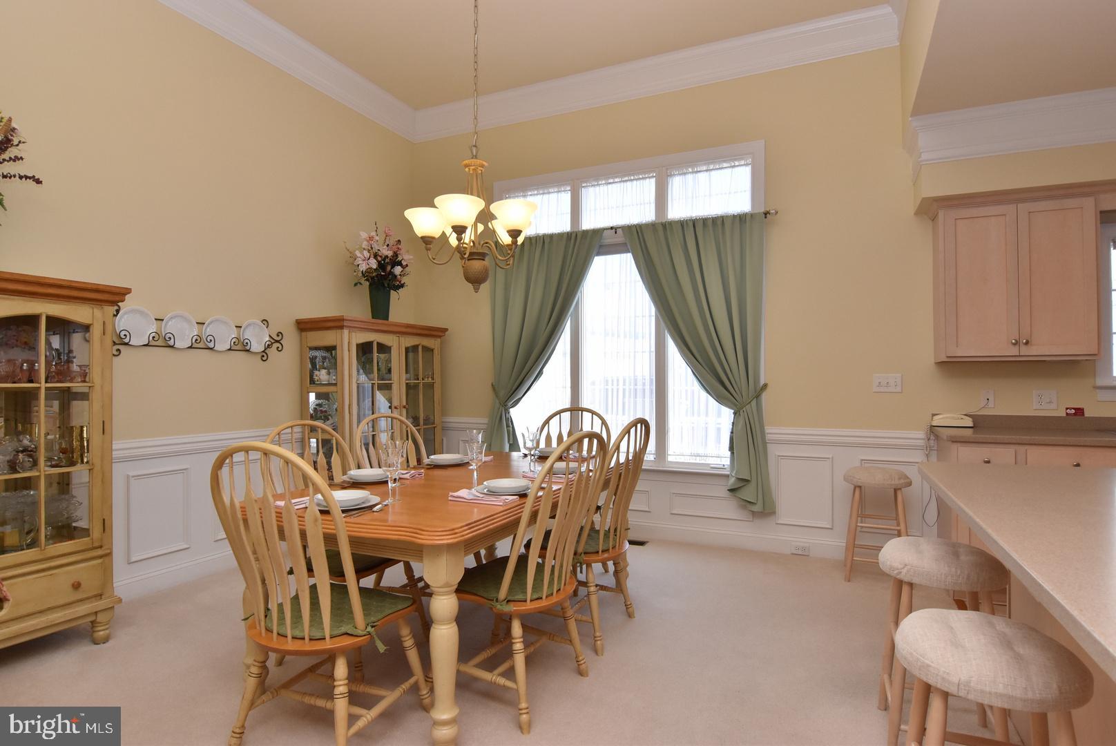 204 Turtle Cove, Unit 115 Laurel, DE 19956 - Photo 6 of 47 a view of a dining room with furniture and chandelier