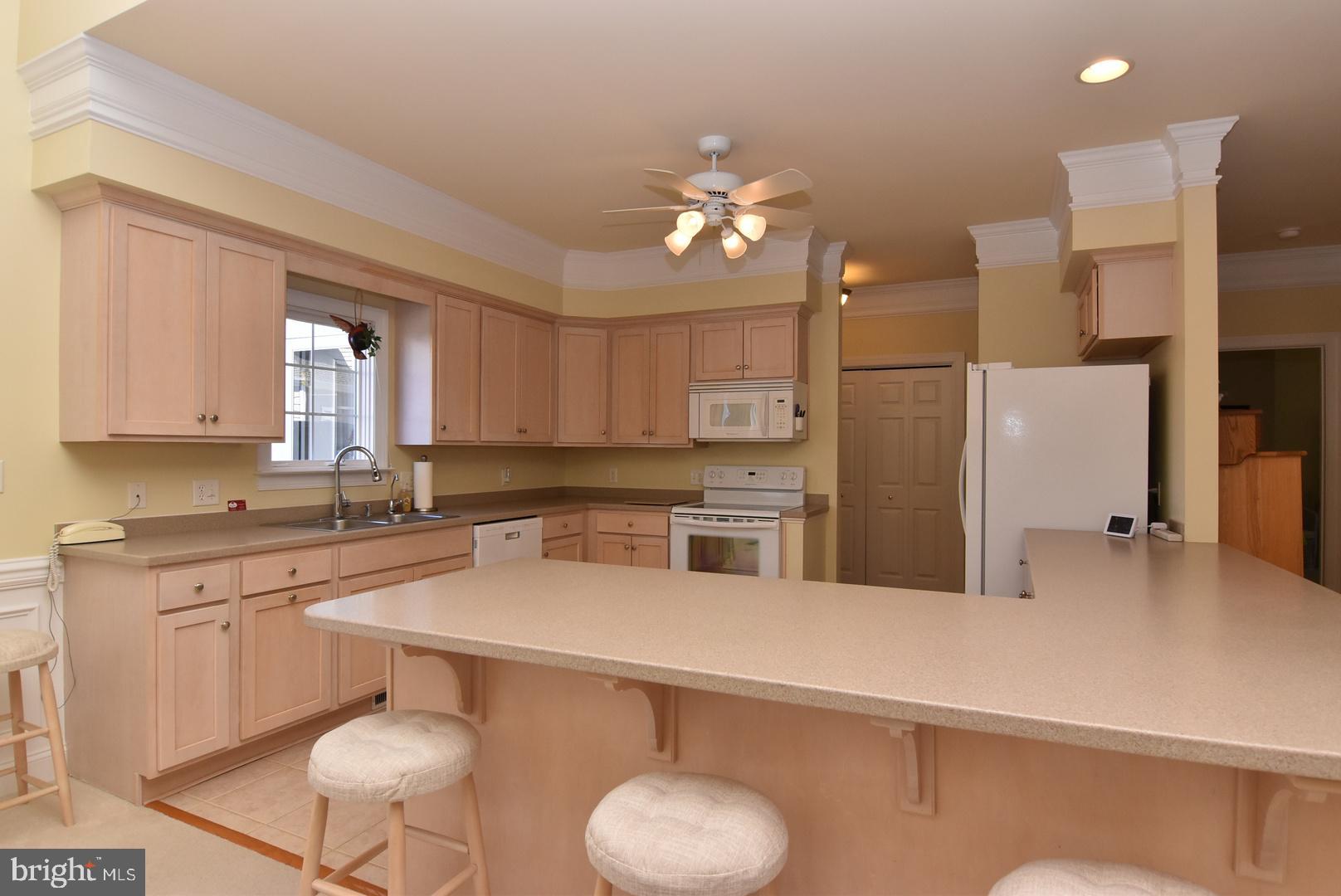 204 Turtle Cove, Unit 115 Laurel, DE 19956 - Photo 8 of 47 a kitchen with a refrigerator a sink cabinets and wooden floor