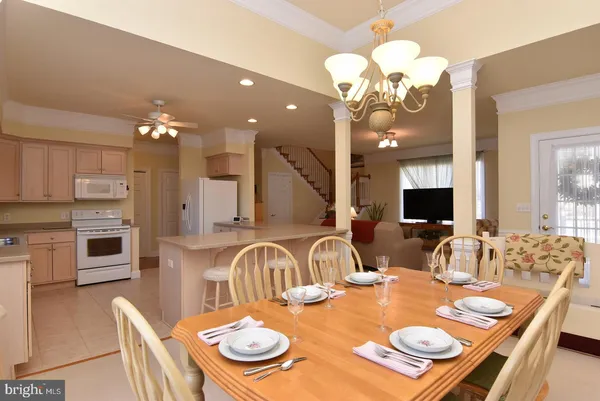 a close view of a dining table chairs and a table
