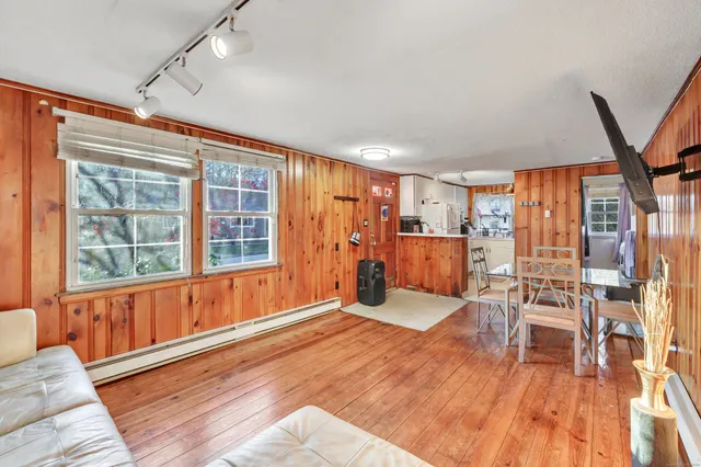 a view of a room with furniture and wooden floor