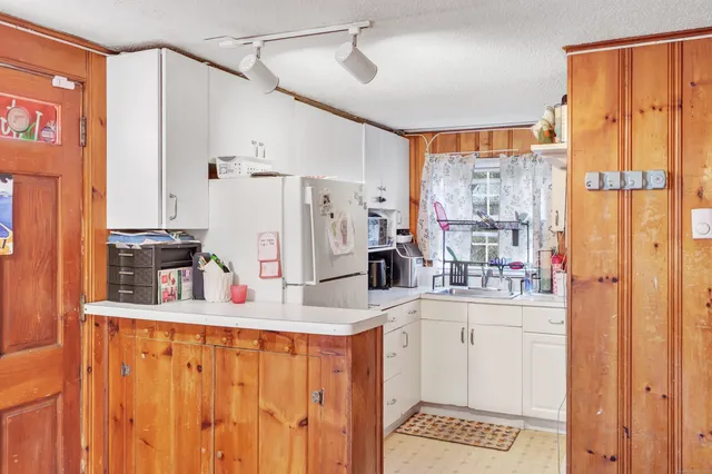 a kitchen with stainless steel appliances granite countertop a refrigerator and a stove