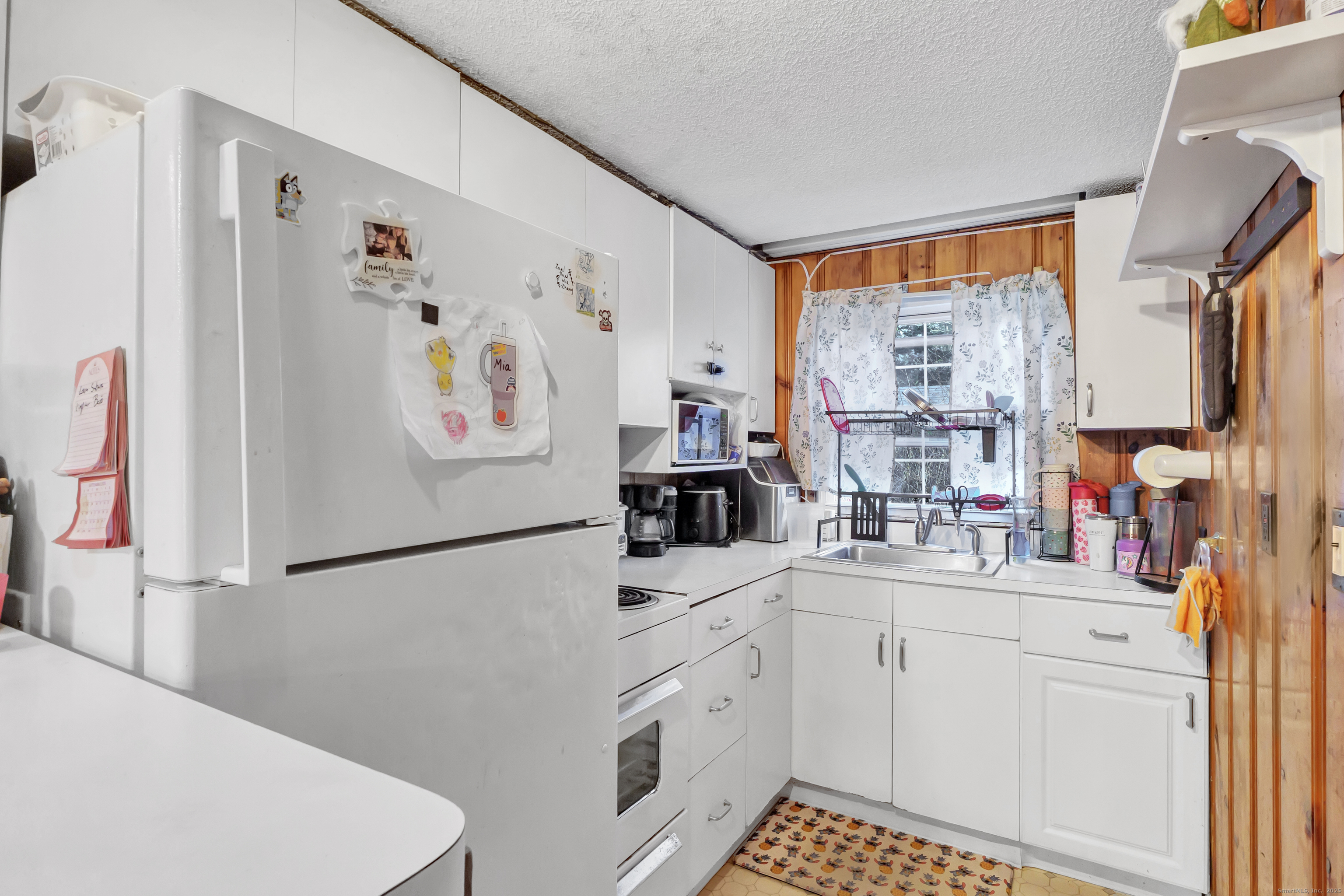 12 Hale Road East Hampton, CT 06424 - Photo 17 of 27 a kitchen with white cabinets and white appliances