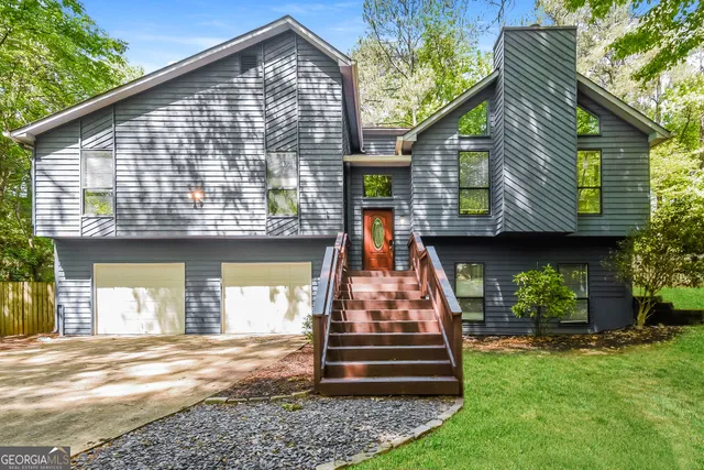 a front view of a house with a garden and plants