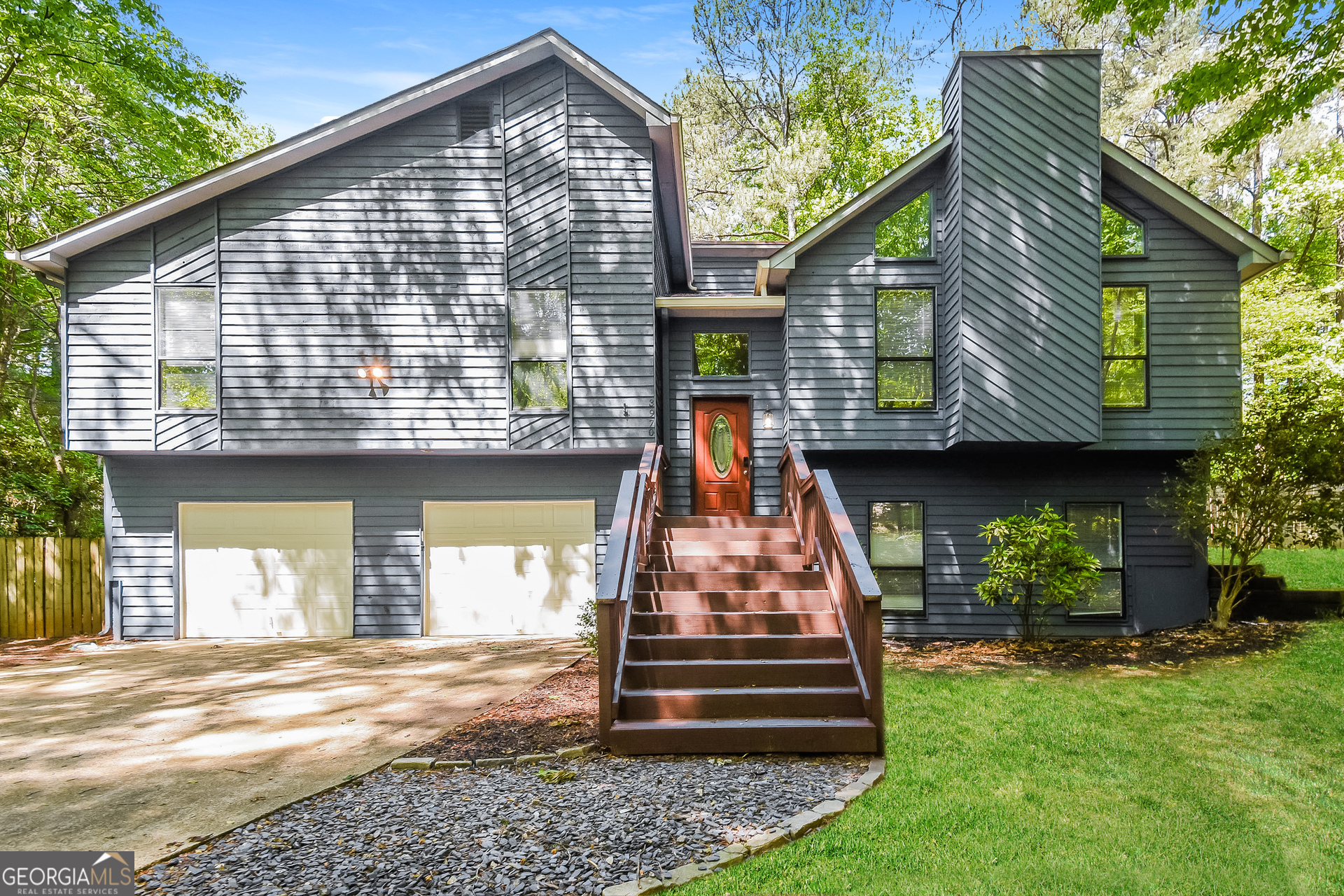 3970 Cripple Creek Drive Kennesaw, GA 30144 - Photo 1 of 17 a front view of a house with a garden and plants