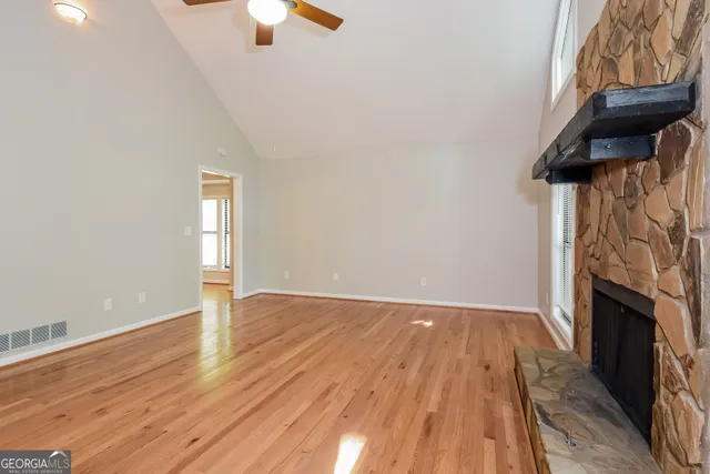 a view of a livingroom with wooden floor and a ceiling fan