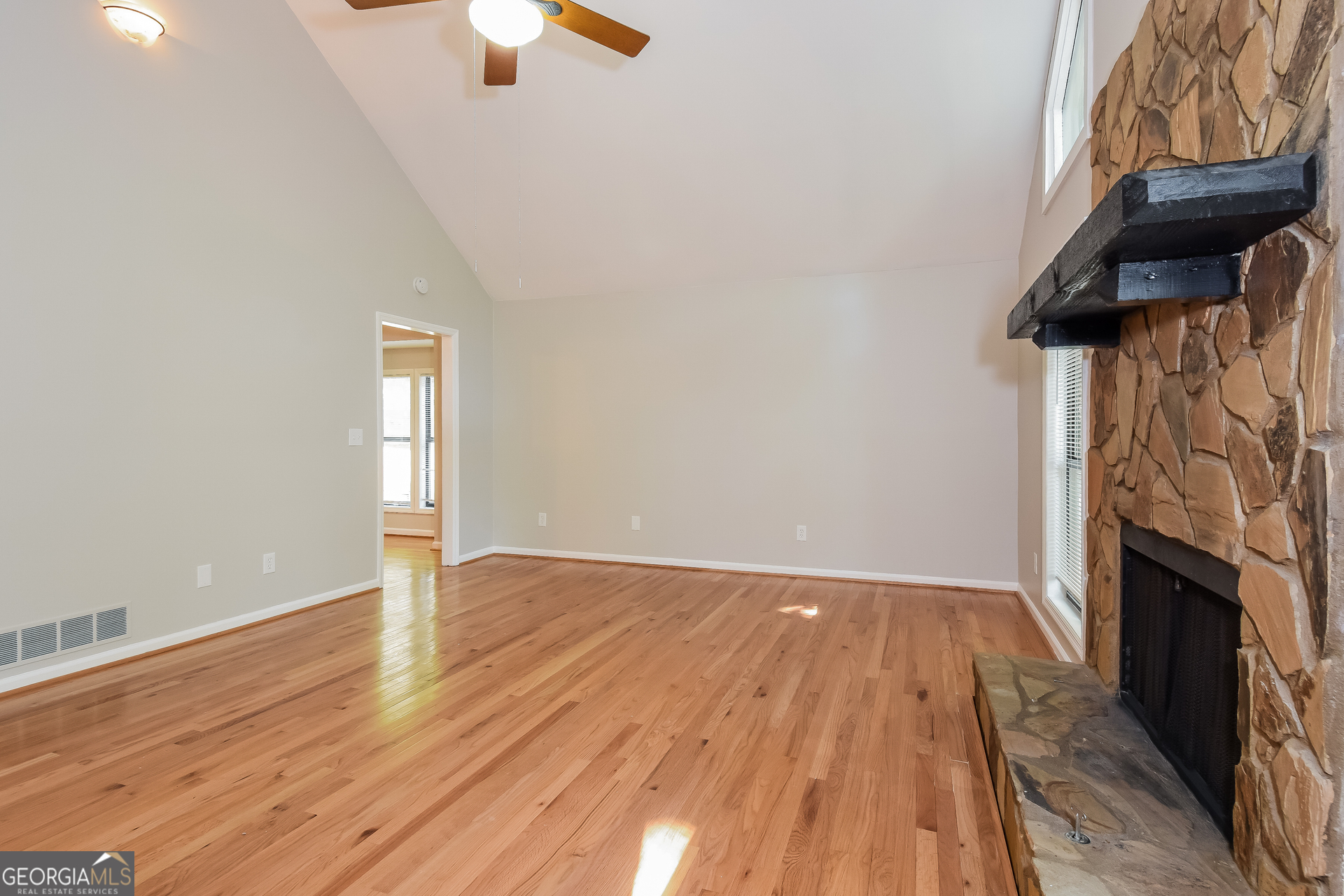 3970 Cripple Creek Drive Kennesaw, GA 30144 - Photo 4 of 17 a view of an empty room with wooden floor fireplace and a window
