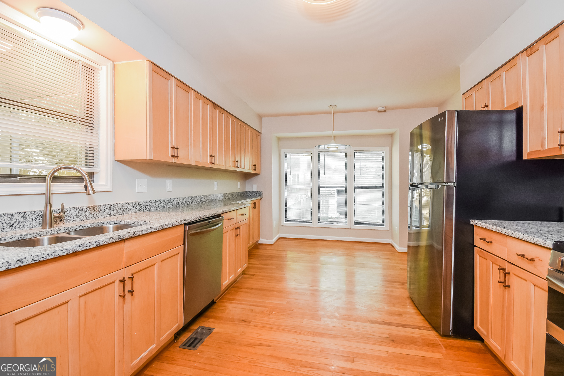 3970 Cripple Creek Drive Kennesaw, GA 30144 - Photo 7 of 17 a kitchen with stainless steel appliances granite countertop a sink stove and refrigerator
