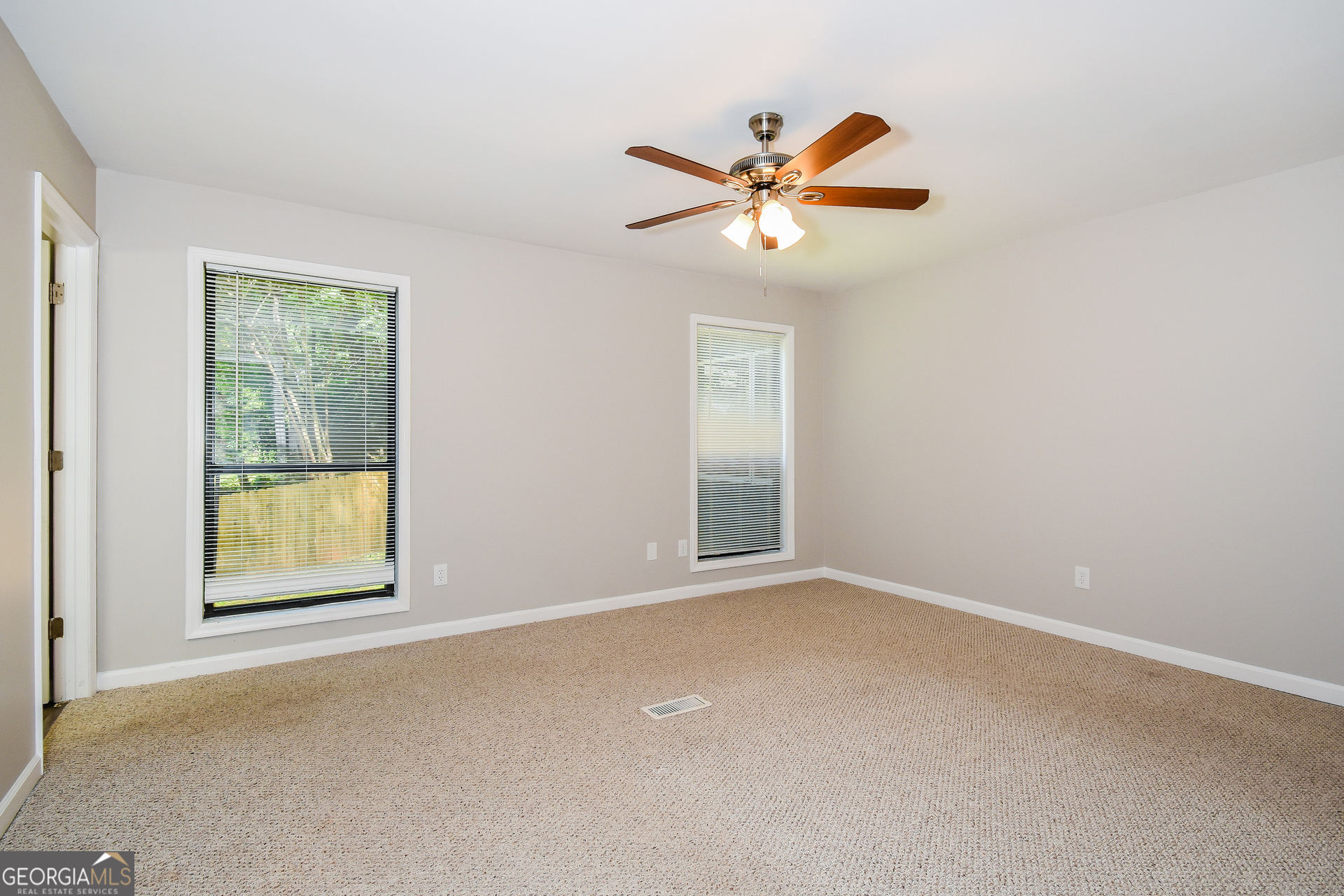 3970 Cripple Creek Drive Kennesaw, GA 30144 - Photo 9 of 17 an empty room with windows and fan