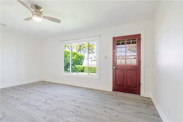 an empty room with windows and closet