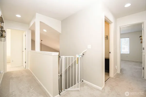 a view of a hallway with a hallway to rooms