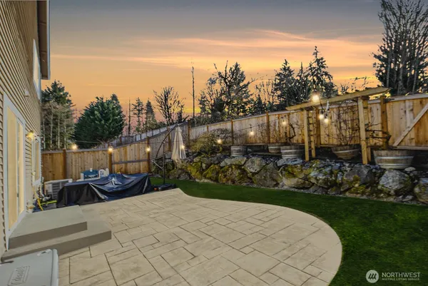 a view of a backyard with sitting area