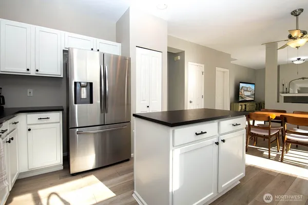 a kitchen with stainless steel appliances a refrigerator sink and cabinets