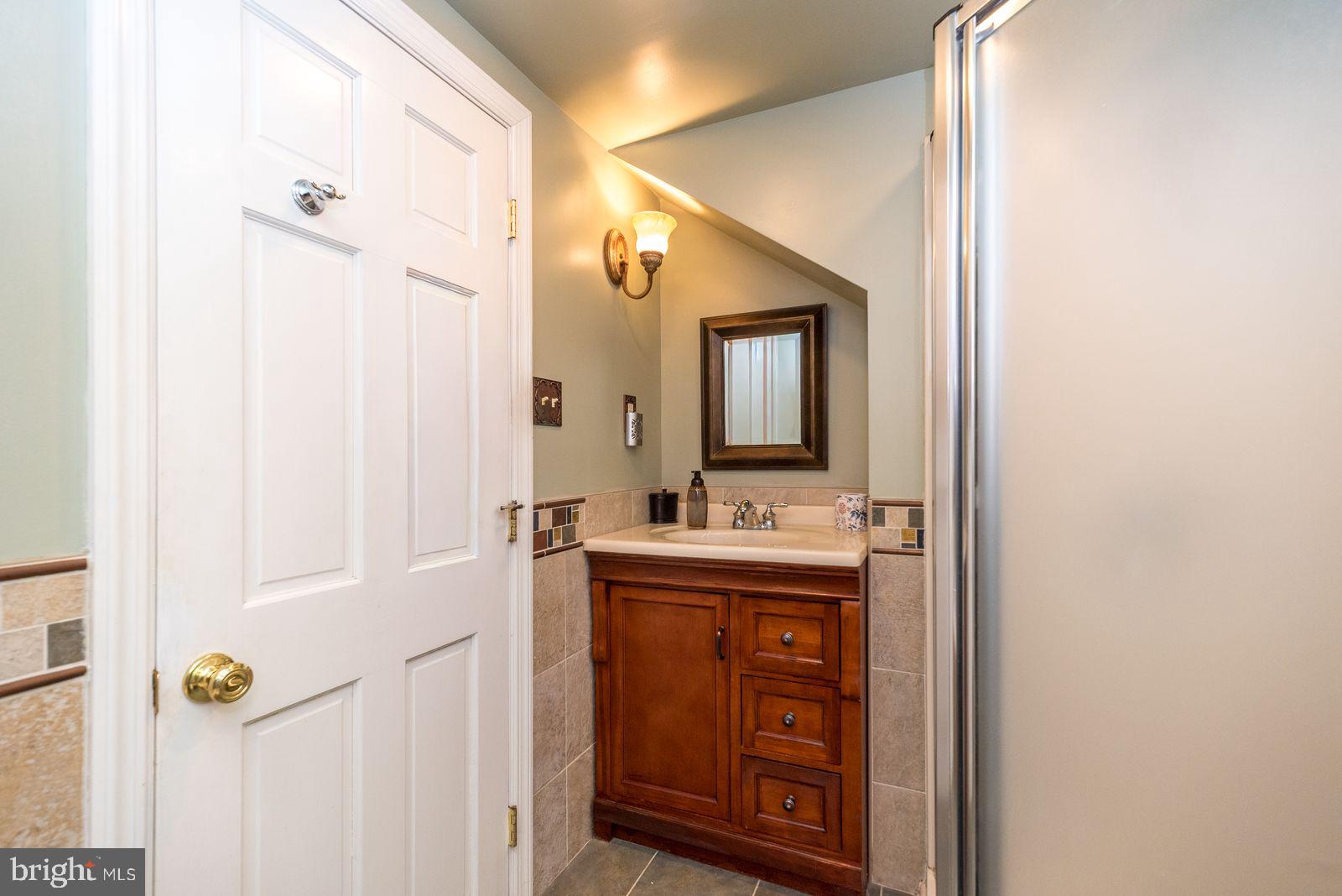 534 Pinney Road Huntingdon Valley, PA 19006 - Photo 18 of 26 a bathroom with a granite countertop sink vanity and mirror
