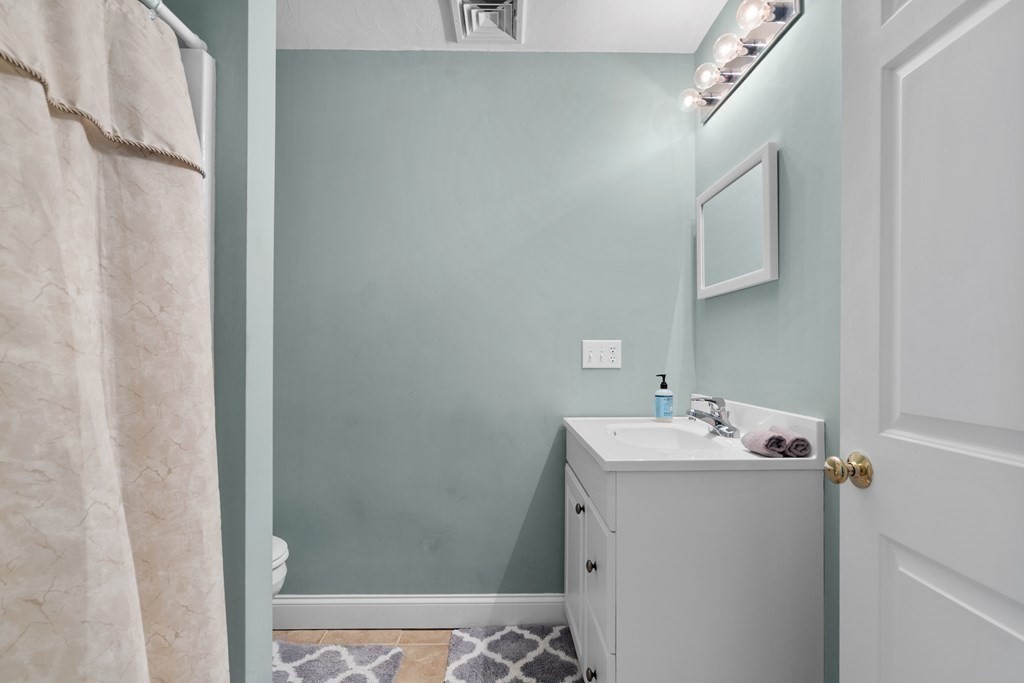 28 North Boulevard Wareham, MA 02558 - Photo 18 of 26 a bathroom with a sink a mirror and shower