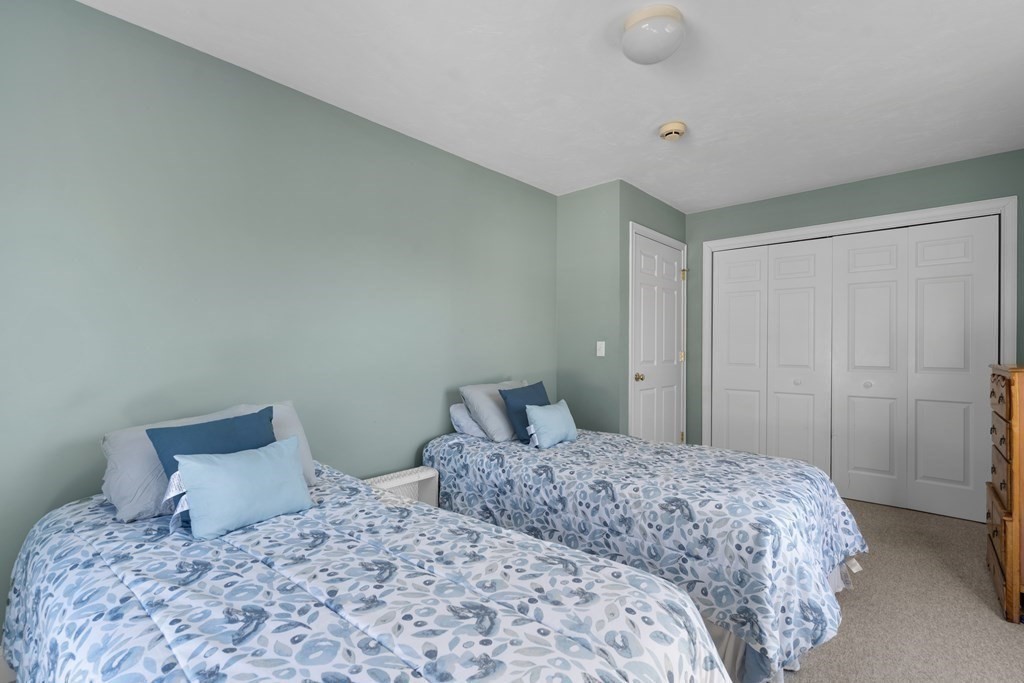 28 North Boulevard Wareham, MA 02558 - Photo 21 of 26 a bedroom with a large bed and a shower