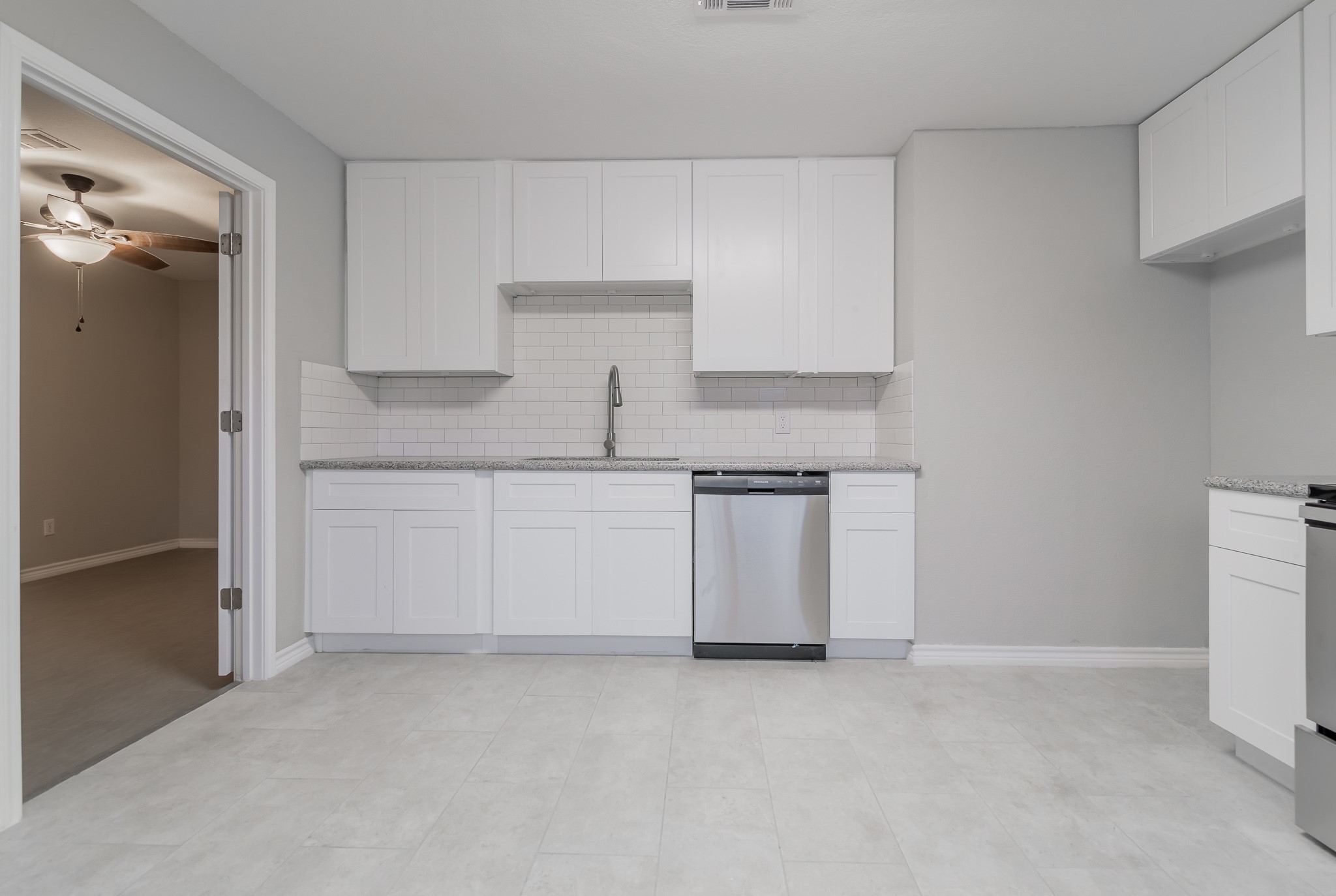 101 Will Street Willis, TX 77378 - Photo 11 of 25 a kitchen with white cabinets and white appliances