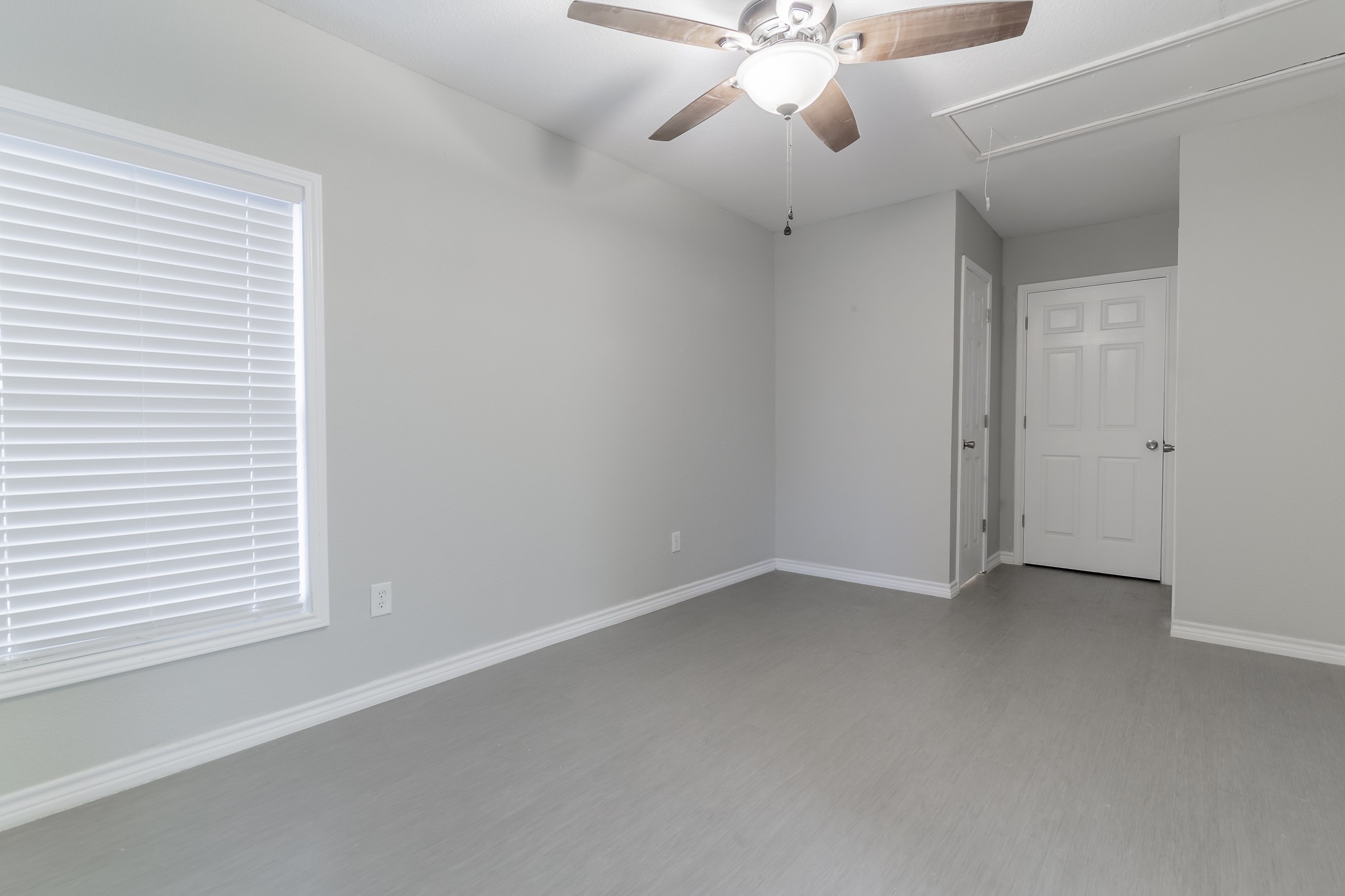 101 Will Street Willis, TX 77378 - Photo 12 of 25 an empty room with a window and a fan