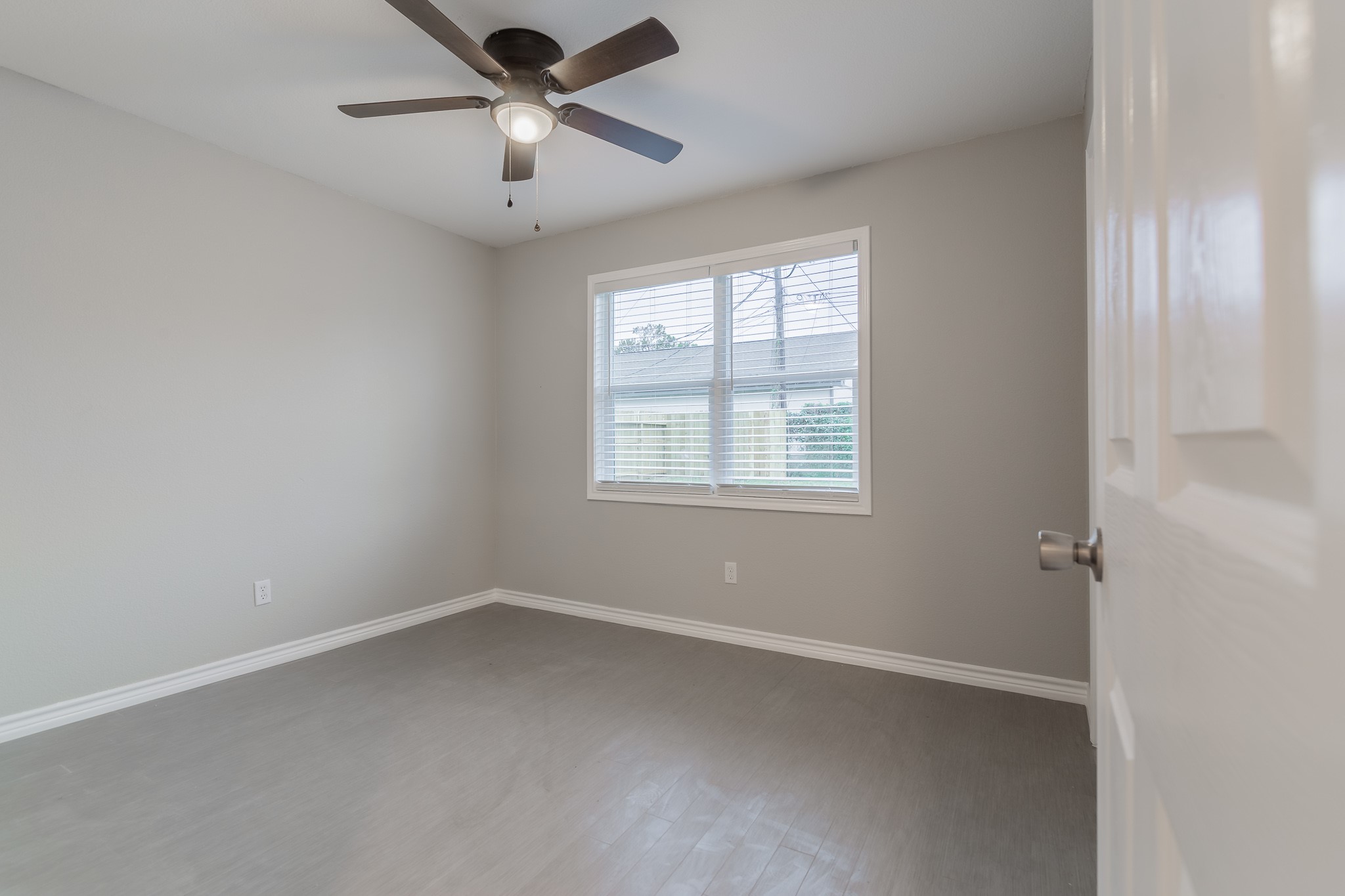 101 Will Street Willis, TX 77378 - Photo 18 of 25 an empty room with a window and a fan