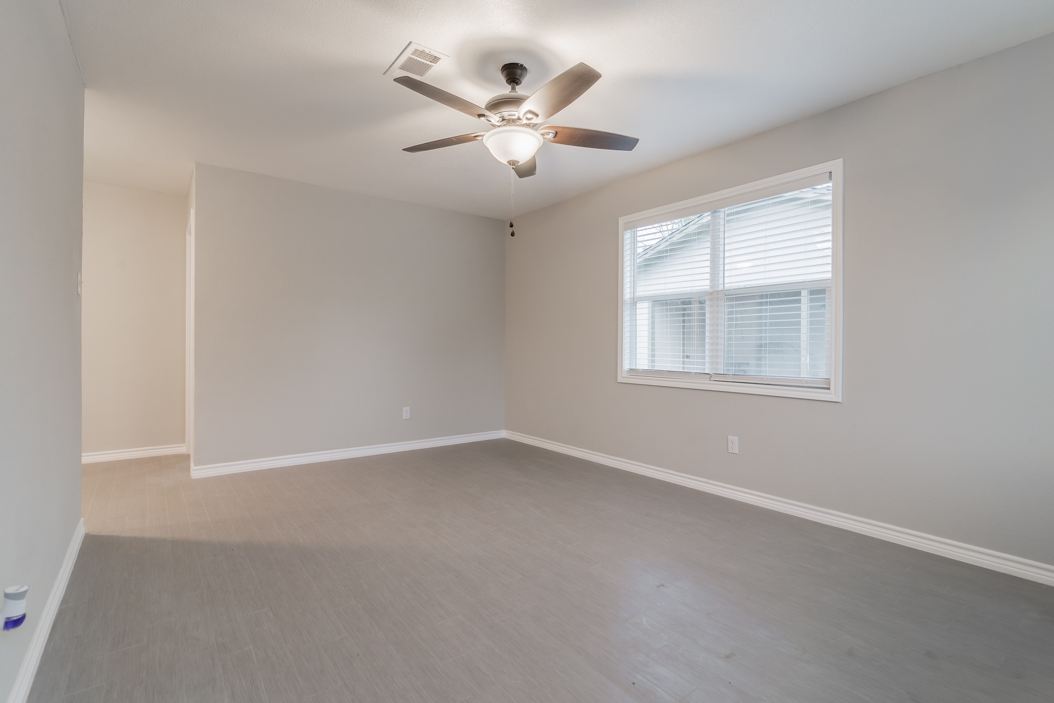 101 Will Street Willis, TX 77378 - Photo 19 of 25 an empty room with ceiling fan and windows