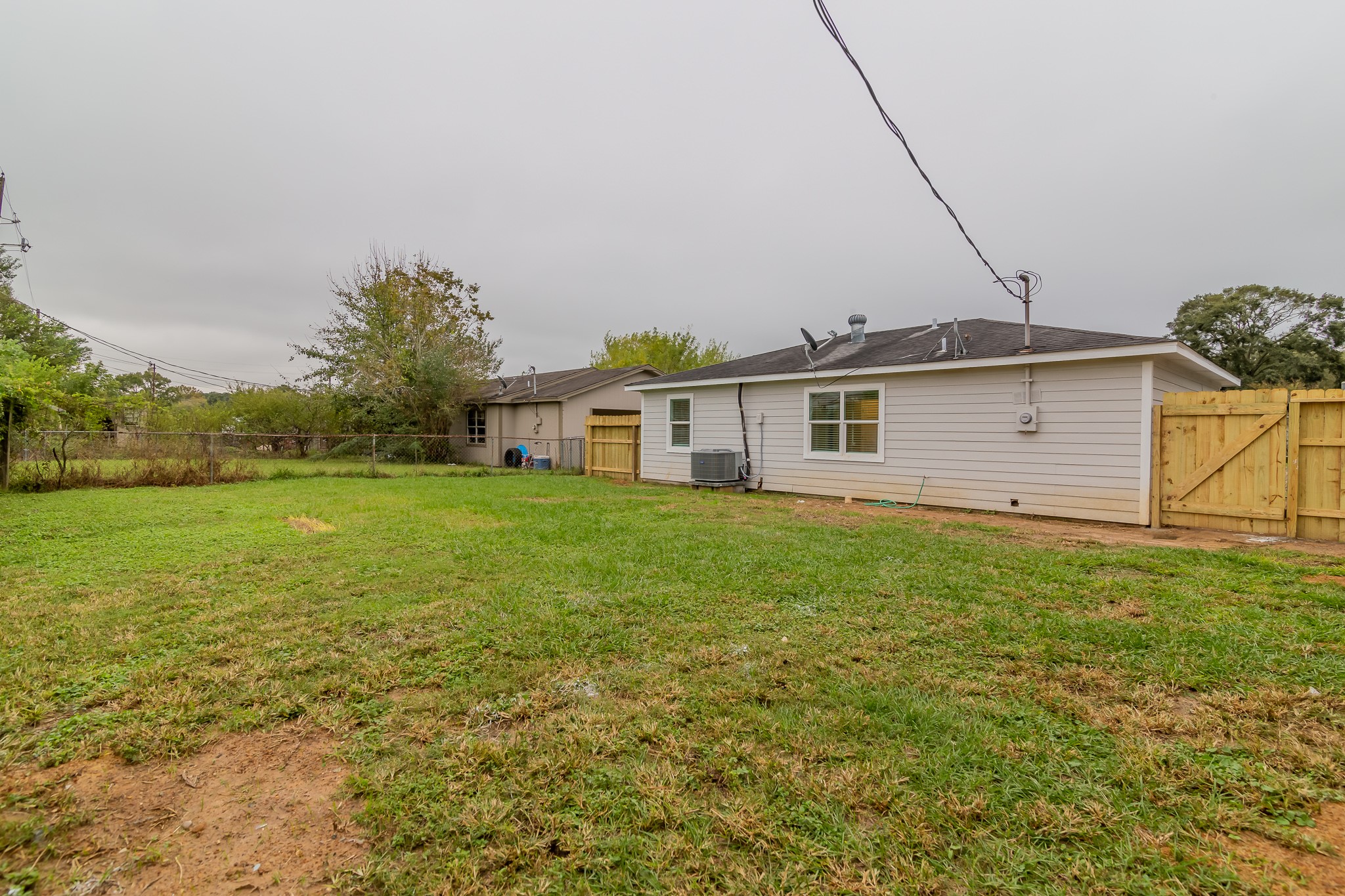101 Will Street Willis, TX 77378 - Photo 22 of 25 a view of a house with a backyard