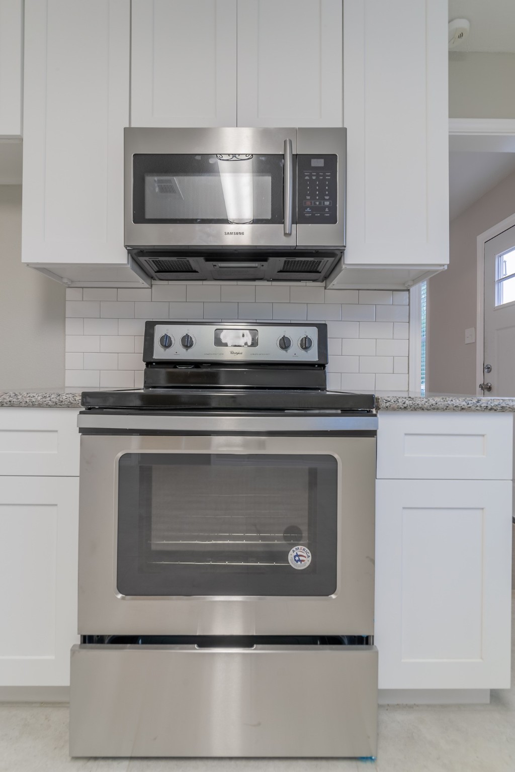 101 Will Street Willis, TX 77378 - Photo 8 of 25 a stove top oven sitting inside of a kitchen