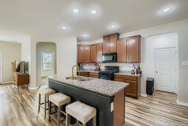 a kitchen with a stove a refrigerator and a sink
