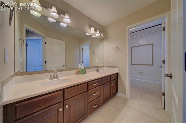 848 Spectrum Loop Colorado Springs, CO 80921 - Photo 27 of 34 Upper hall bath with tub/shower/dual sinks