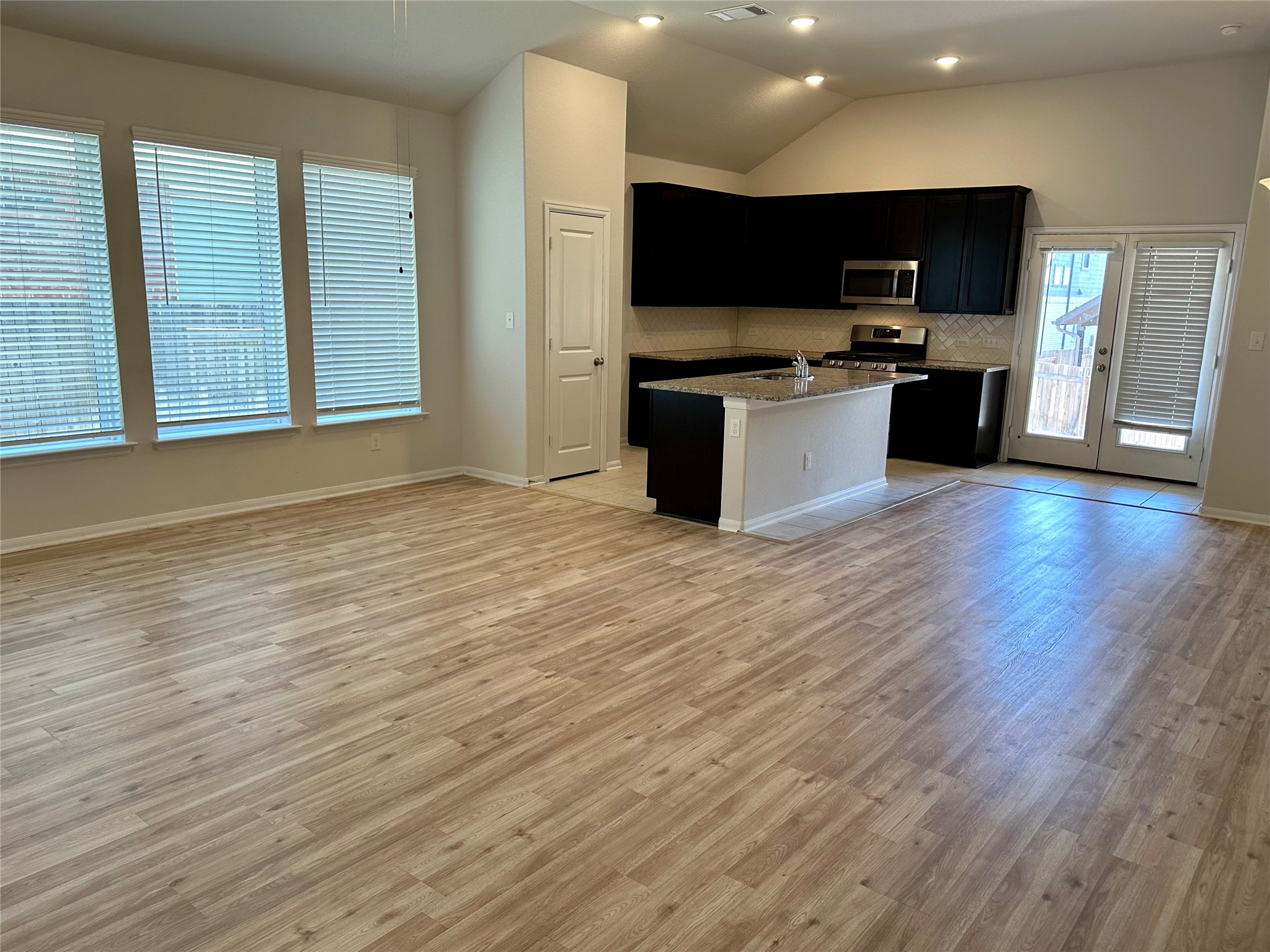 1003 Cherrystone Loop Buda, TX 78610 - Photo 27 of 27 a view of kitchen with stainless steel appliances wooden floor and cabinets