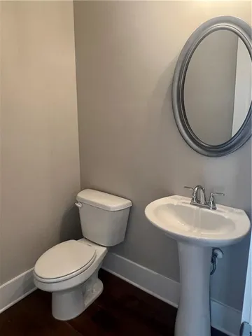 a bathroom with a toilet a sink and a mirror