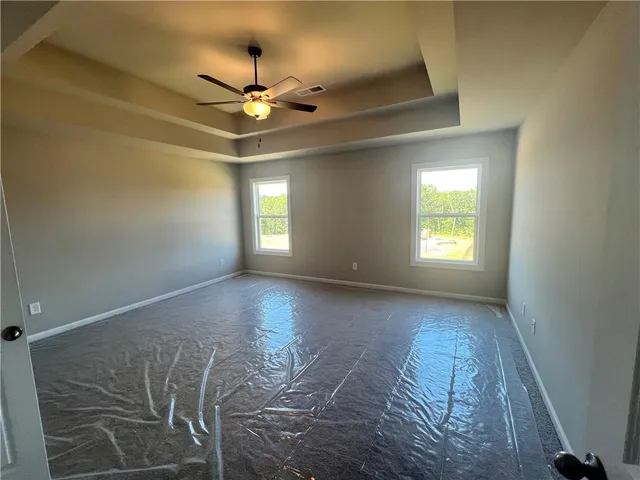 a view of a livingroom with a ceiling fan and window