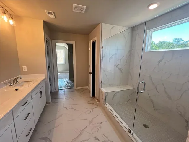 a spacious bathroom with a bathtub shower and sink