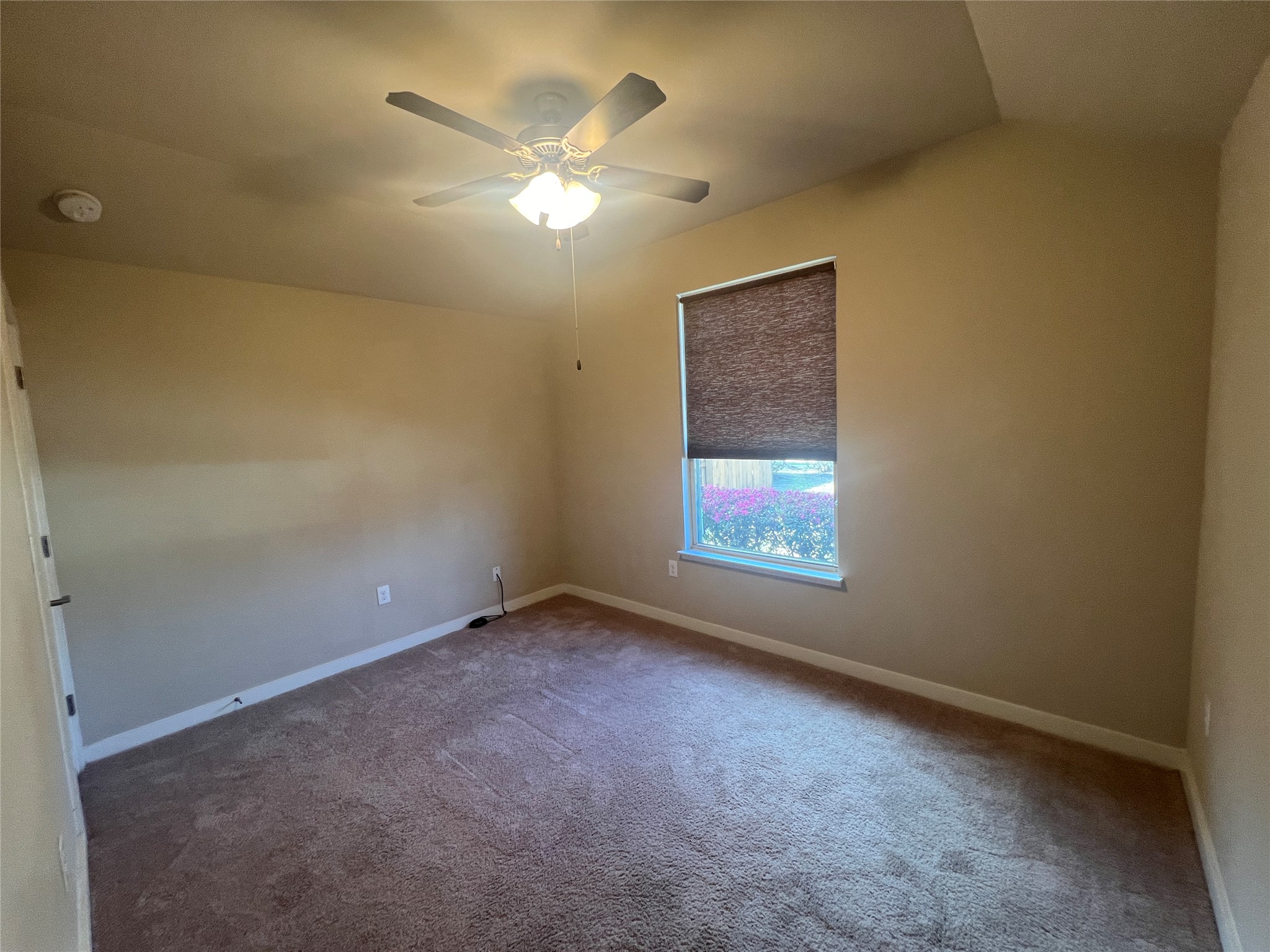 7009 Sienna Rouge Path Austin, TX 78744 - Photo 15 of 29 Carpeted empty room with lofted ceiling and a ceiling fan