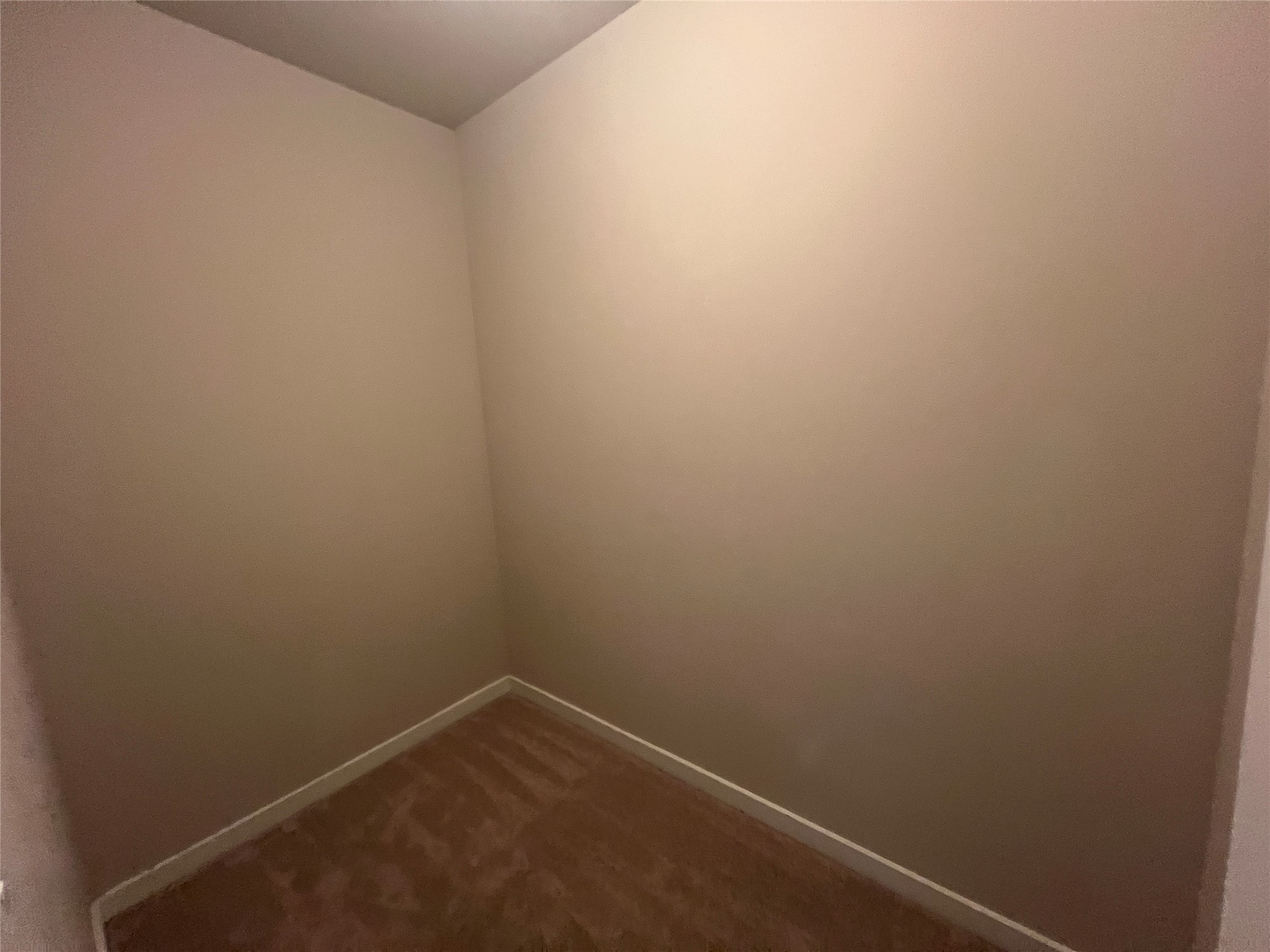 7009 Sienna Rouge Path Austin, TX 78744 - Photo 16 of 29 Spare room featuring baseboards and dark carpet