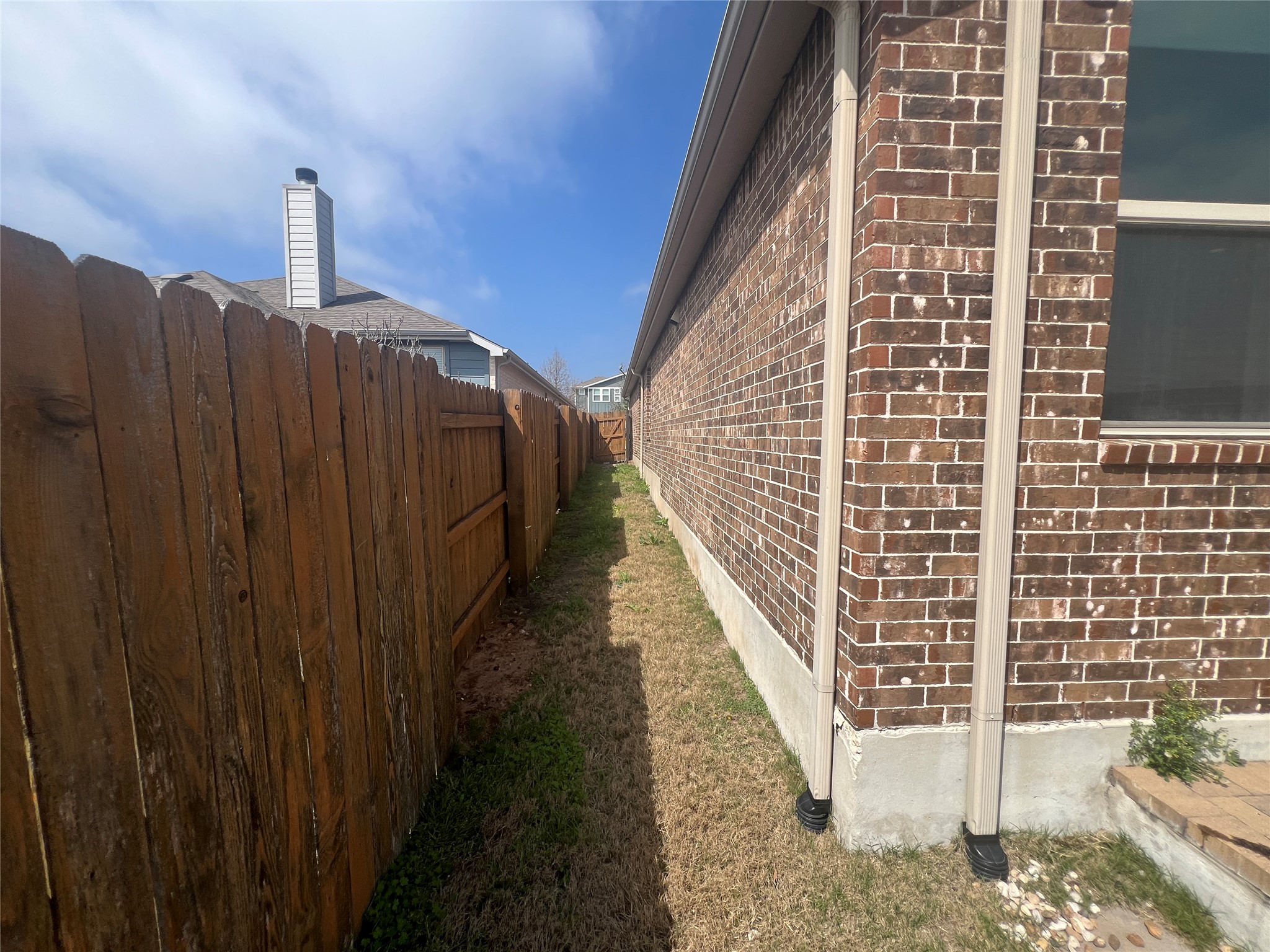7009 Sienna Rouge Path Austin, TX 78744 - Photo 20 of 29 View of property exterior featuring brick siding