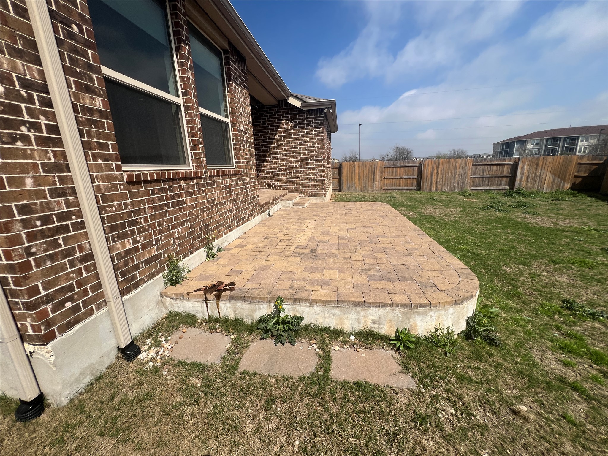 7009 Sienna Rouge Path Austin, TX 78744 - Photo 21 of 29 Fenced yard with a patio area