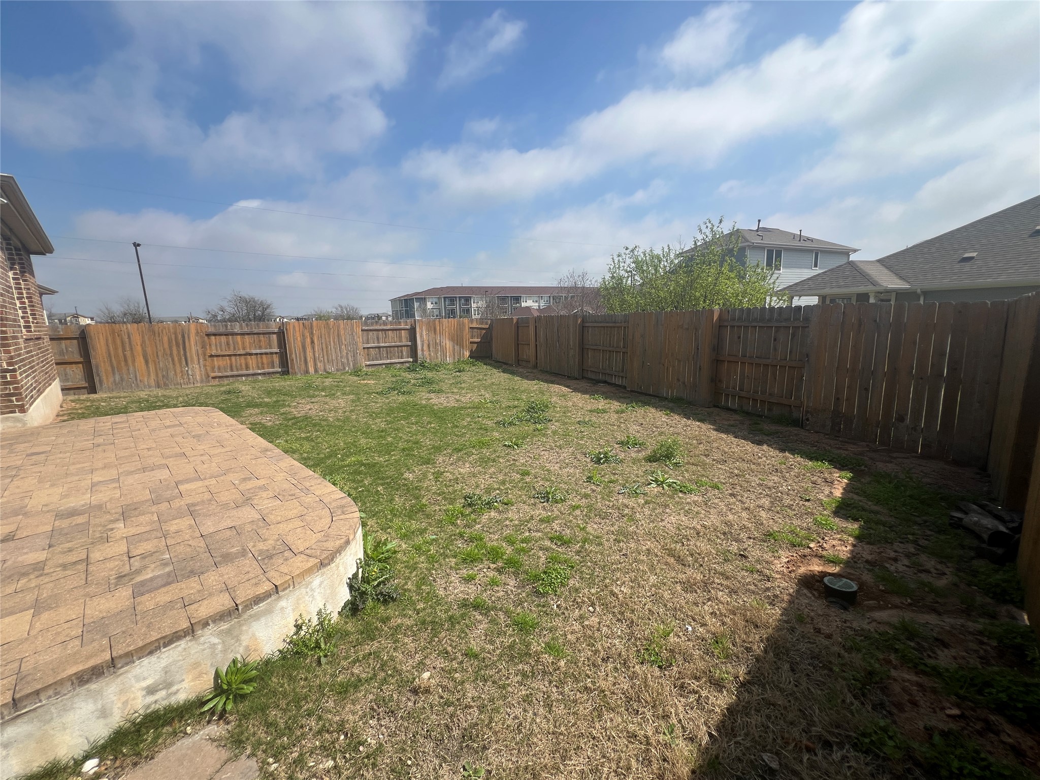 7009 Sienna Rouge Path Austin, TX 78744 - Photo 22 of 29 Fenced backyard featuring a patio