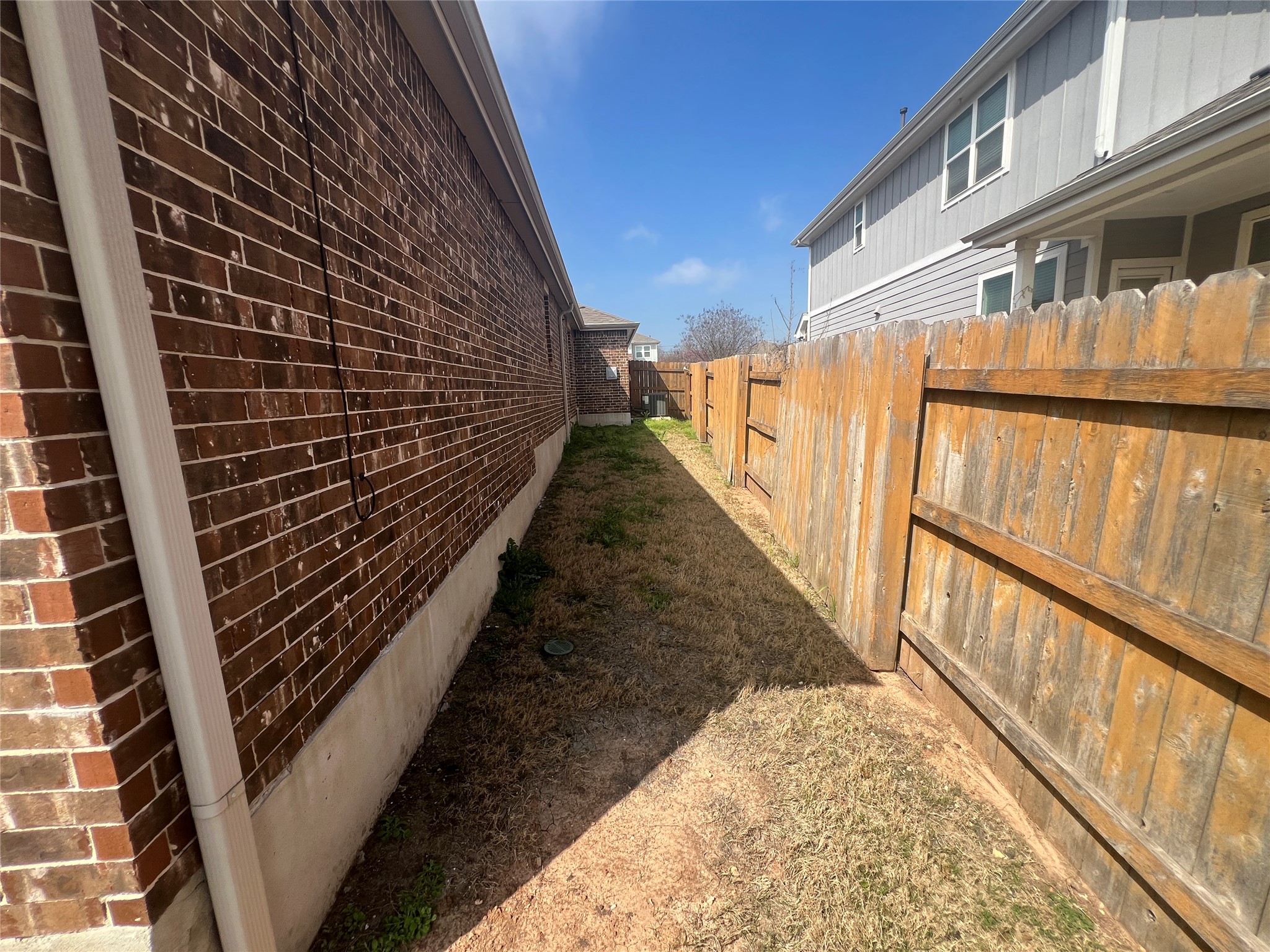 7009 Sienna Rouge Path Austin, TX 78744 - Photo 23 of 29 View of side of property with brick siding