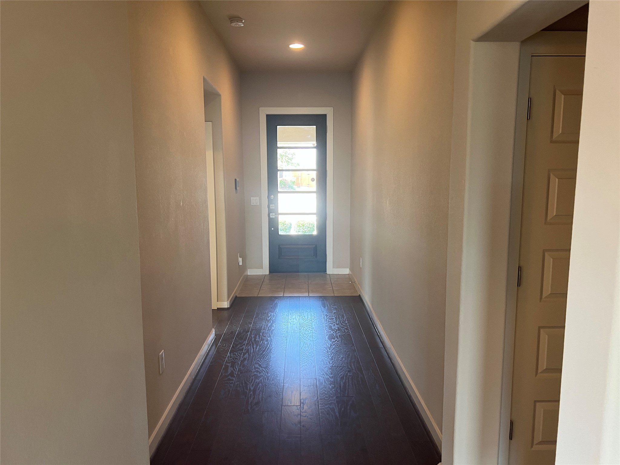 7009 Sienna Rouge Path Austin, TX 78744 - Photo 7 of 29 Doorway featuring wood-type flooring and recessed lighting