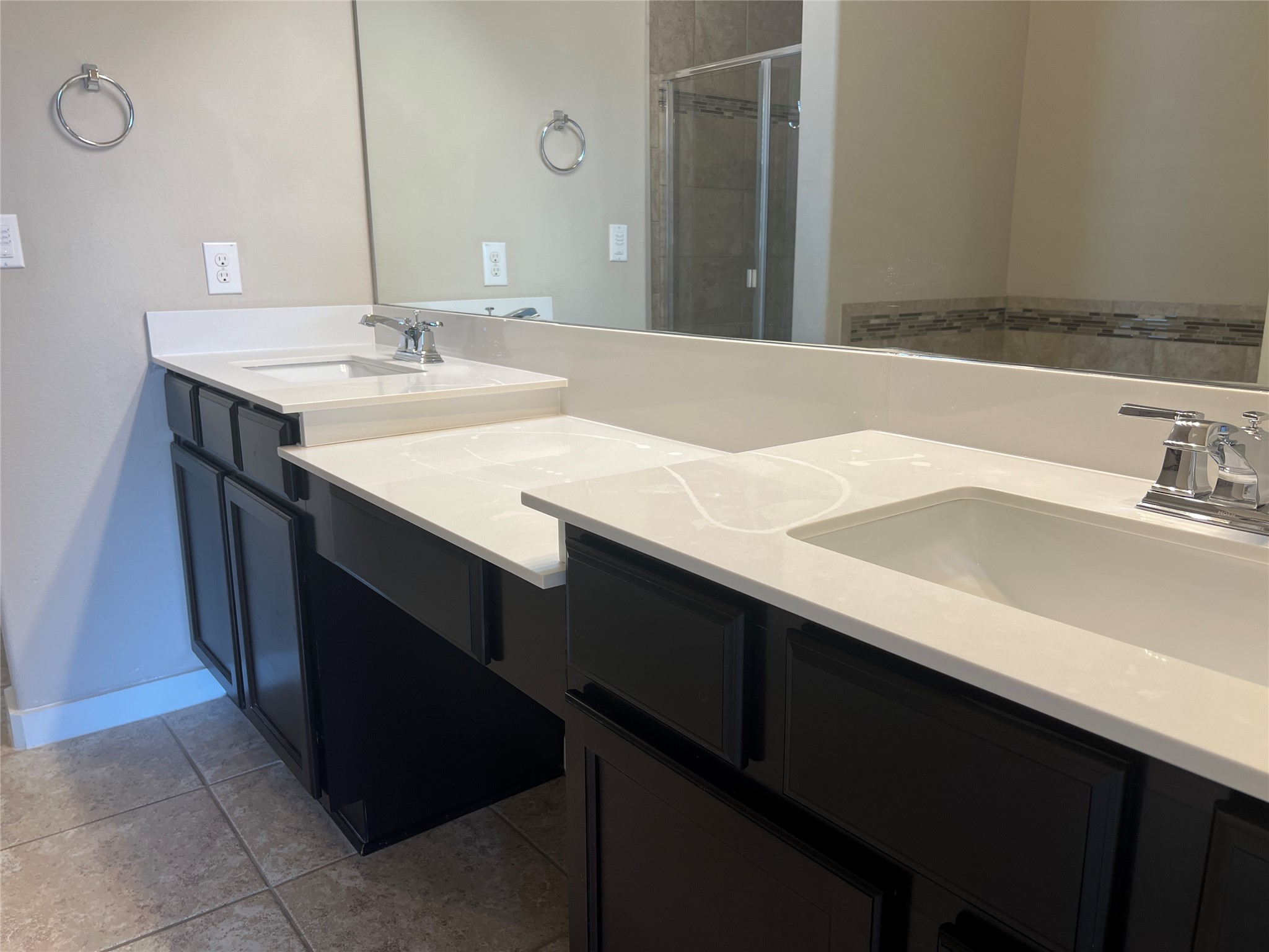 7009 Sienna Rouge Path Austin, TX 78744 - Photo 9 of 29 Full bath with double vanity, a shower stall, and light tile patterned floors