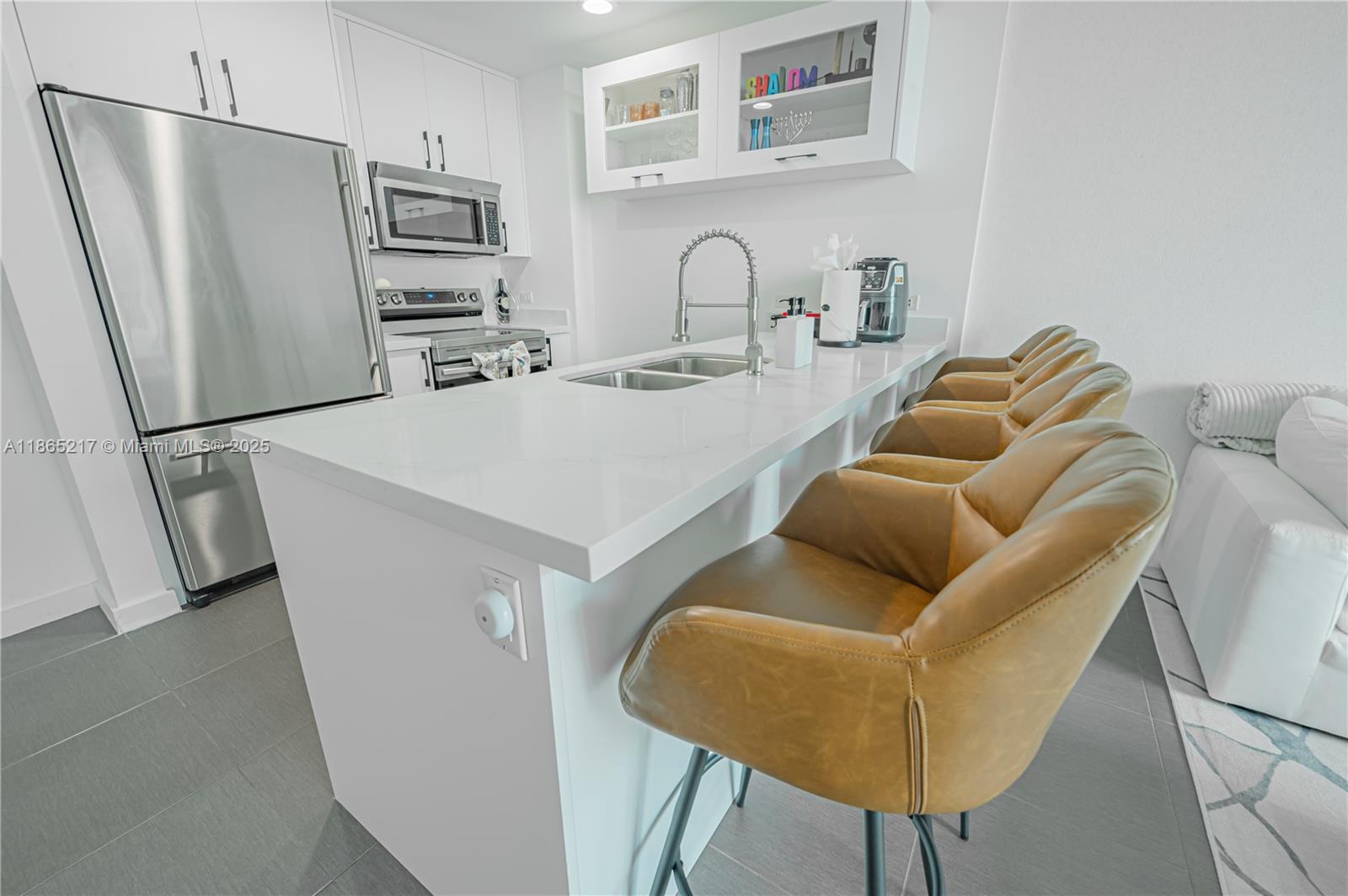 3301 Northeast 1st Avenue, Unit M0703 Miami, FL 33137 - Photo 23 of 48 a kitchen with stainless steel appliances a refrigerator and a table