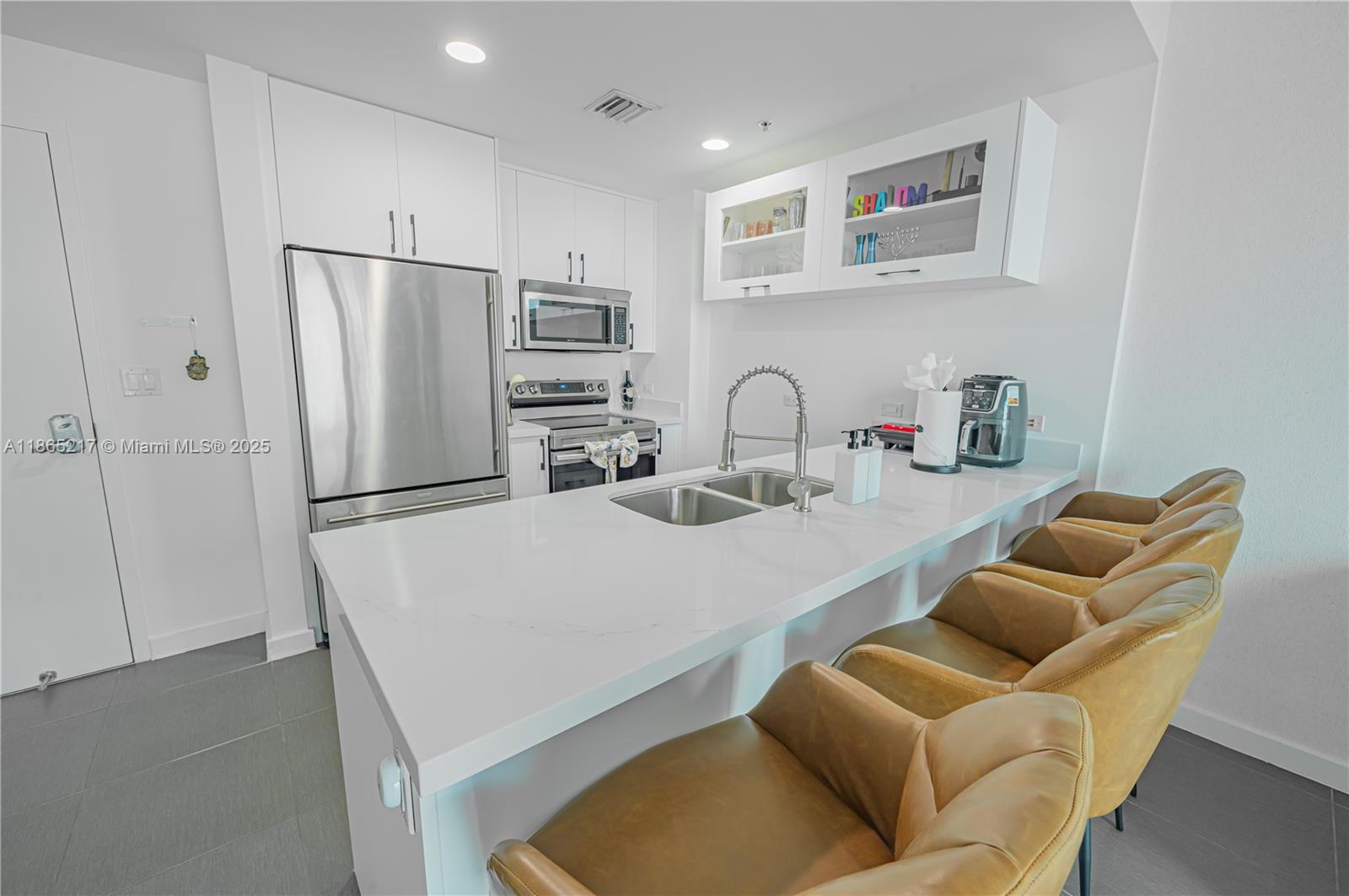 3301 Northeast 1st Avenue, Unit M0703 Miami, FL 33137 - Photo 28 of 48 a kitchen with stainless steel appliances granite countertop a refrigerator and a sink