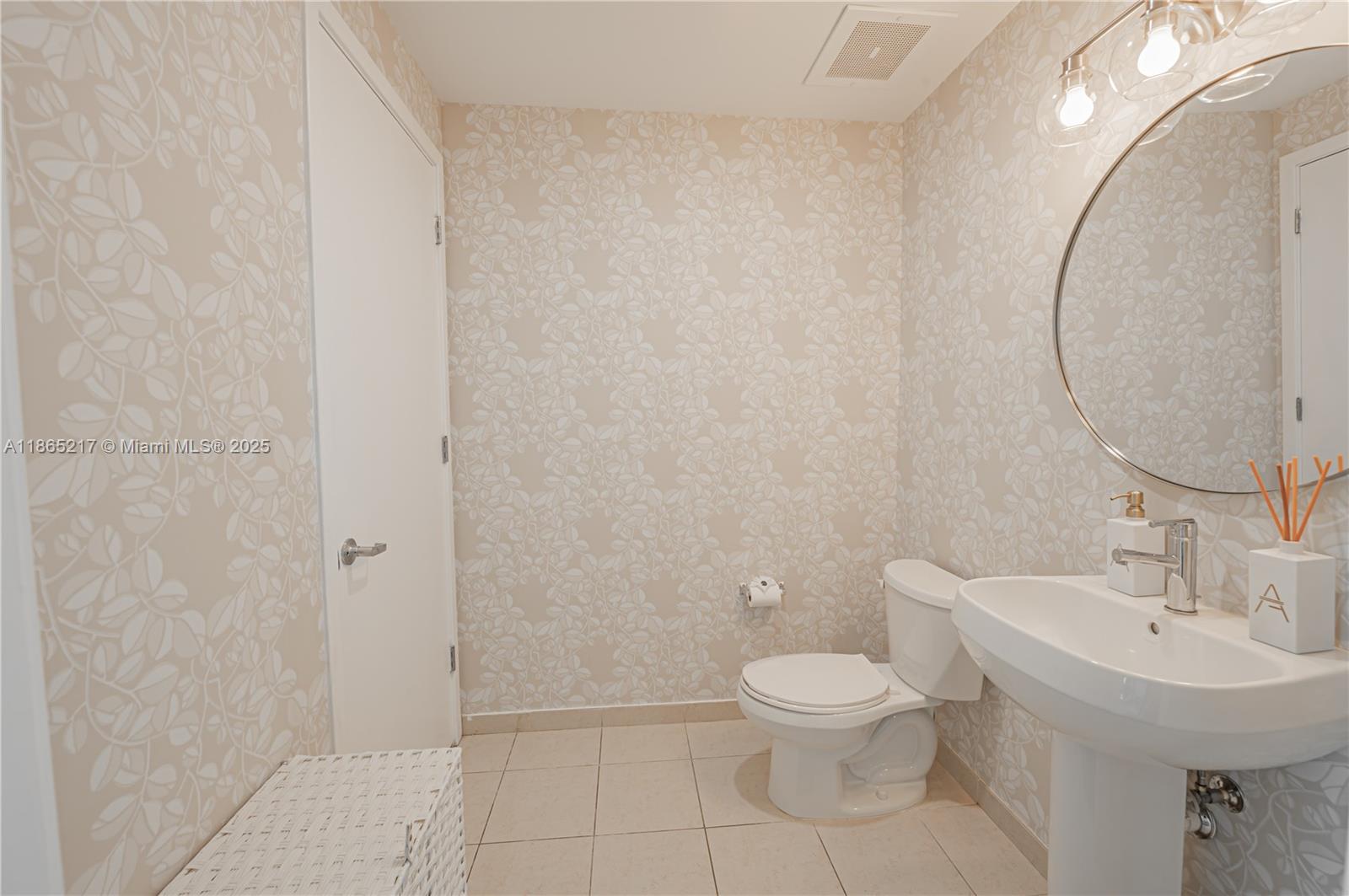 3301 Northeast 1st Avenue, Unit M0703 Miami, FL 33137 - Photo 35 of 48 a bathroom with a toilet a sink and mirror