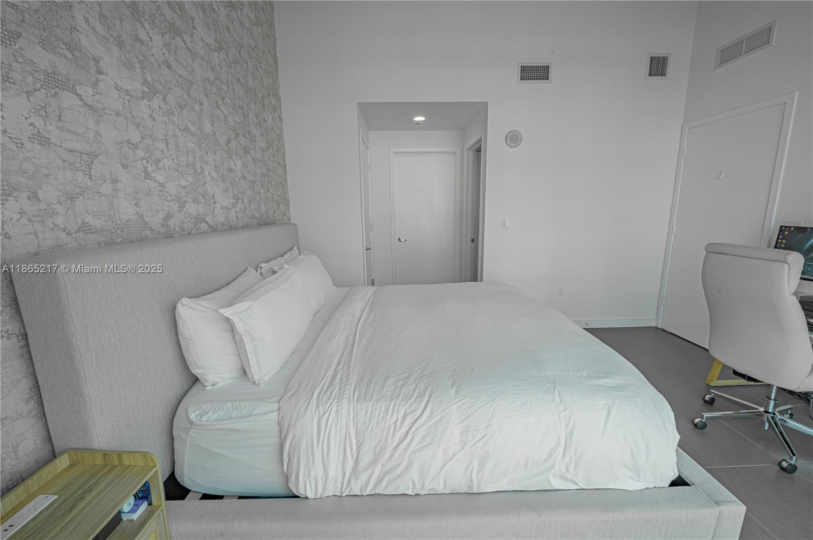 3301 Northeast 1st Avenue, Unit M0703 Miami, FL 33137 - Photo 40 of 48 a bedroom with a bed and chair
