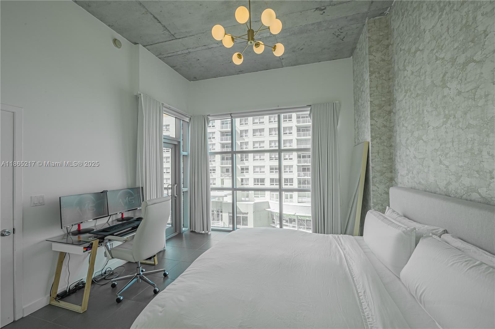 3301 Northeast 1st Avenue, Unit M0703 Miami, FL 33137 - Photo 41 of 48 a bedroom with a bed and a chandelier