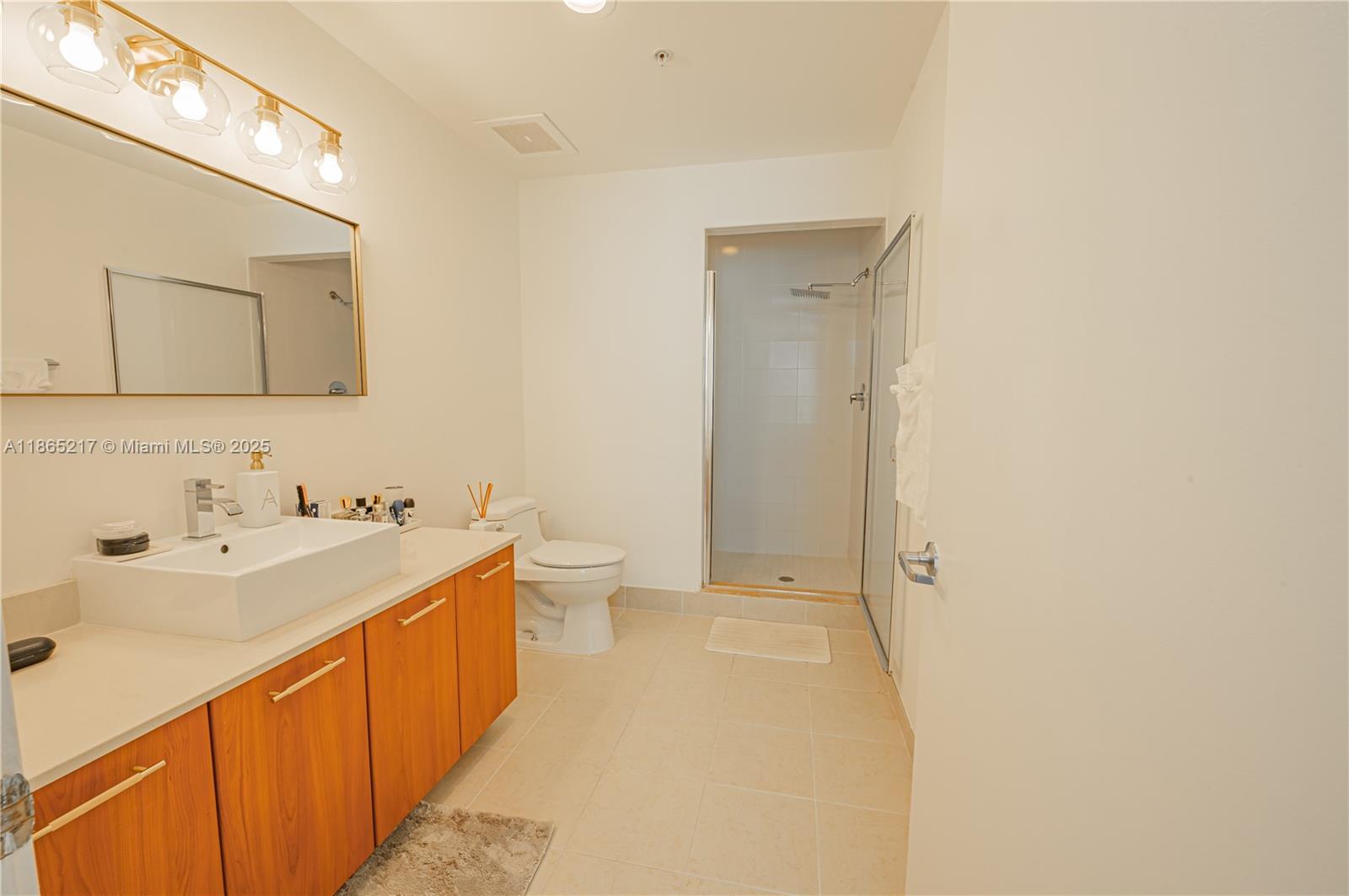 3301 Northeast 1st Avenue, Unit M0703 Miami, FL 33137 - Photo 46 of 48 a view of a bathroom with a sink and mirror