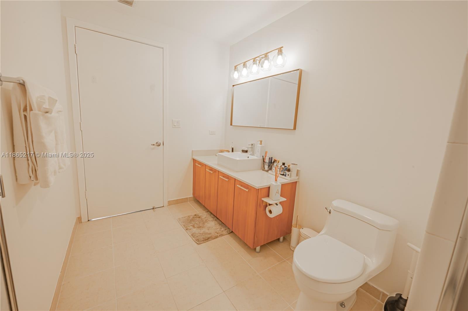 3301 Northeast 1st Avenue, Unit M0703 Miami, FL 33137 - Photo 47 of 48 a bathroom with a sink mirror vanity and toilet