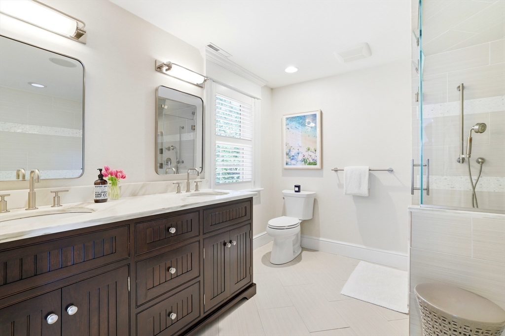 85 Old Farm Road Milton, MA 02186 - Photo 16 of 42 a spacious bathroom with a double vanity sink toilet mirror and bathtub